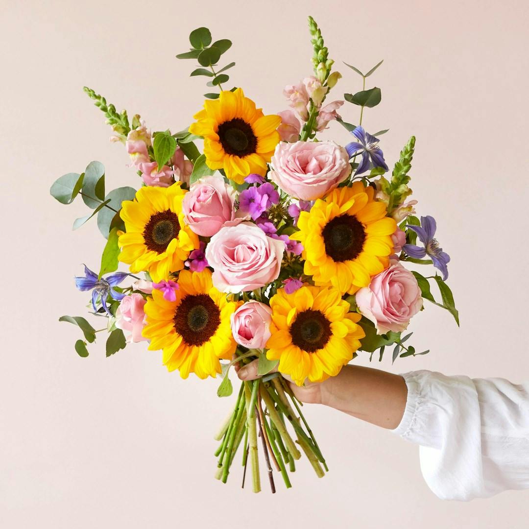 person holding bunch of flowers