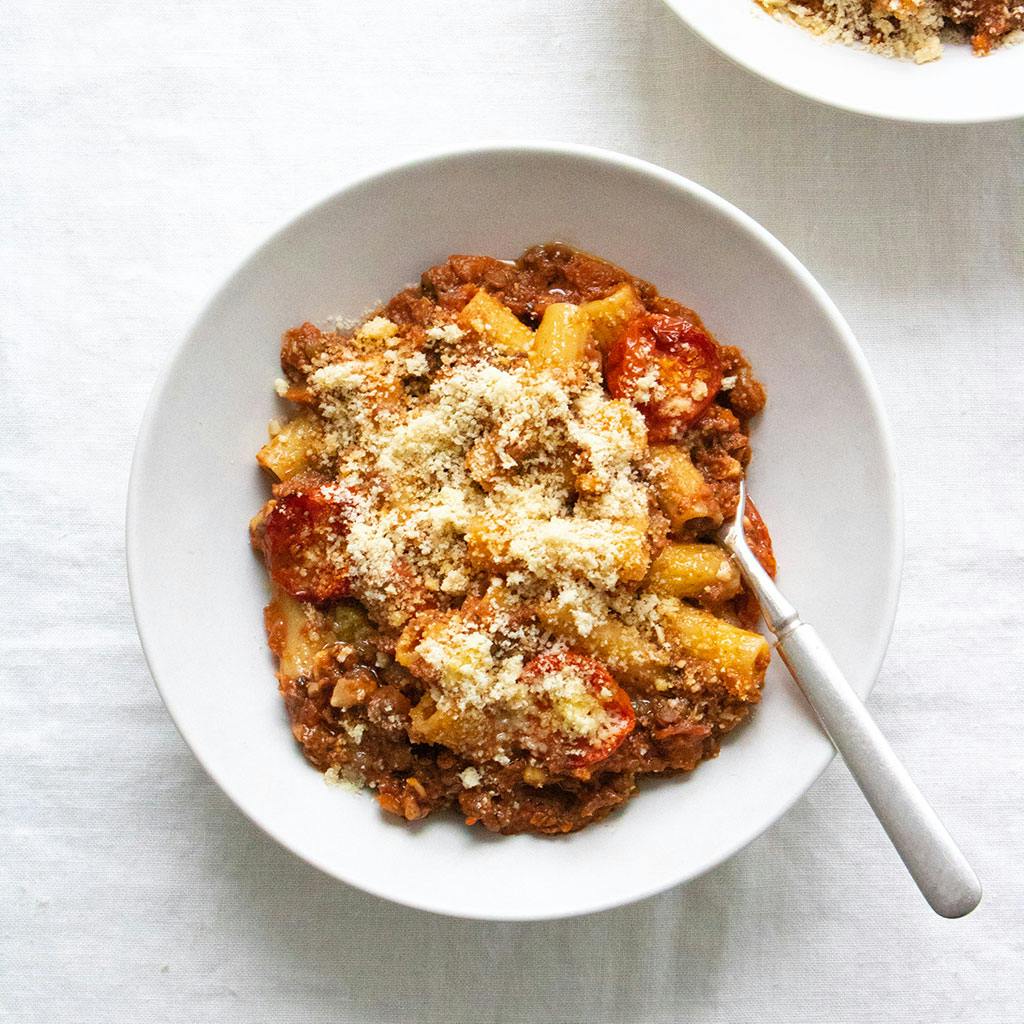 a bowl of rigatoni bolognese