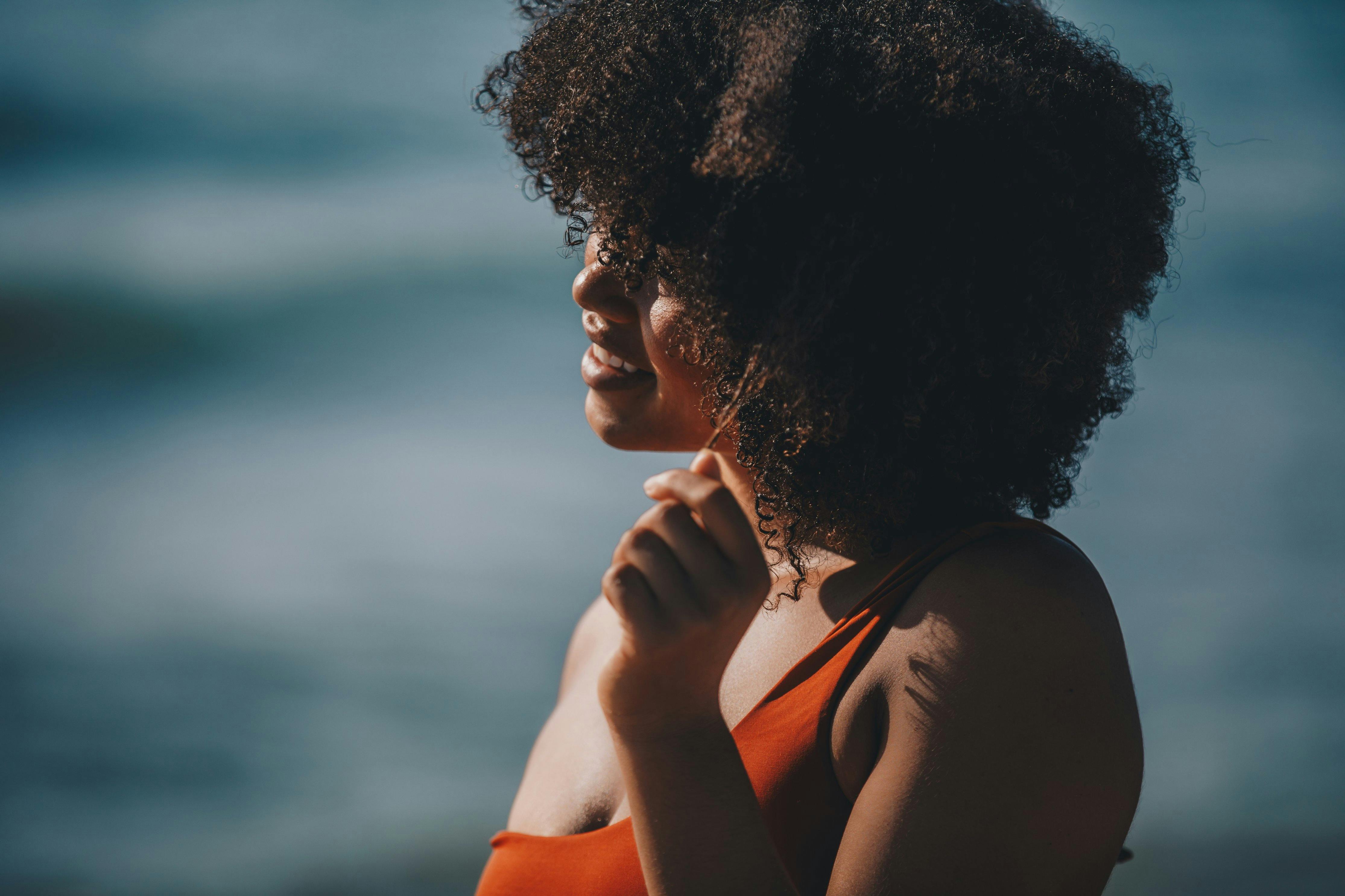 woman on a beach playing with her hair