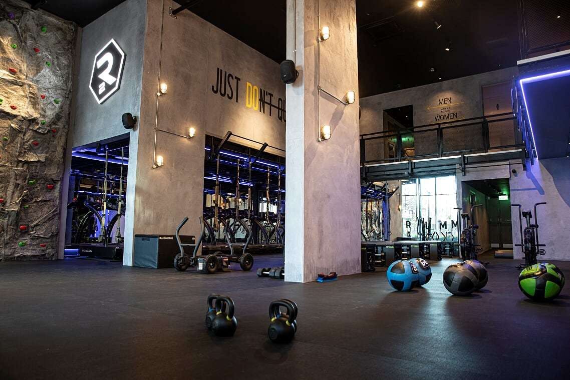 a large open gym space with a climbing wall 