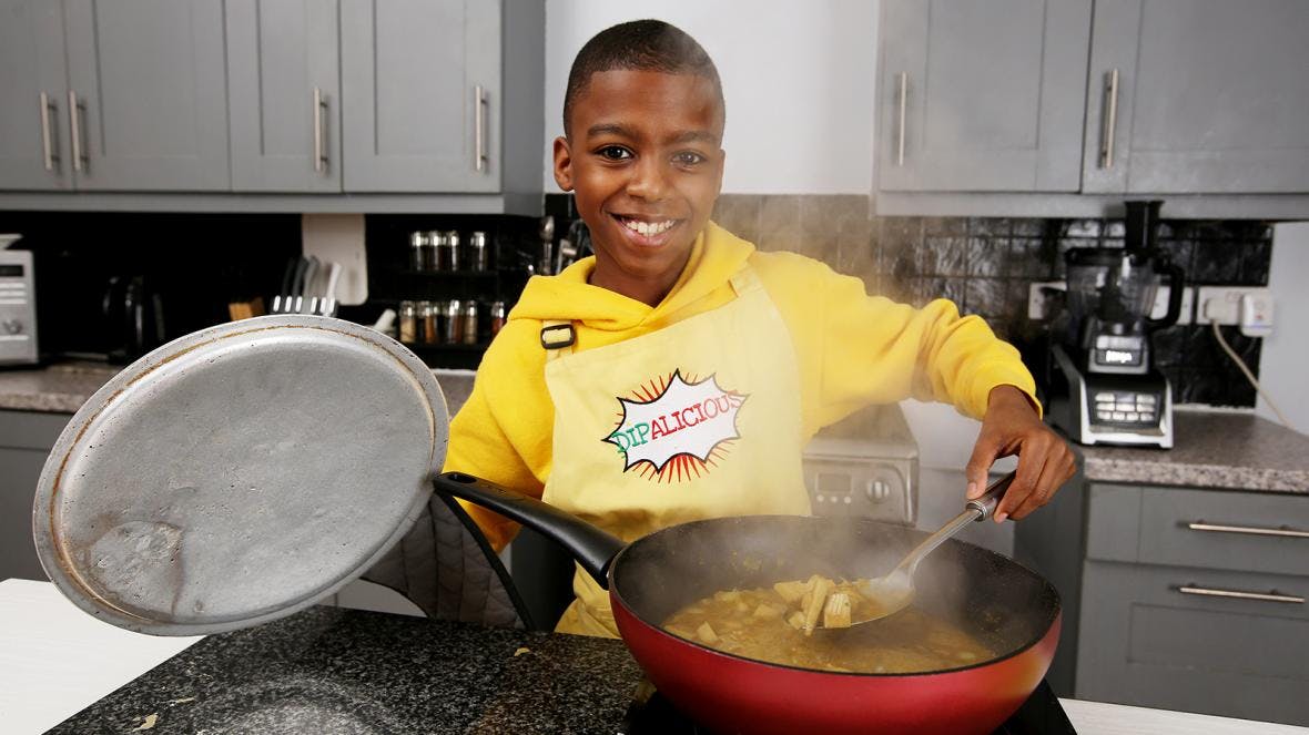 Che Omar McQueen in kitchen