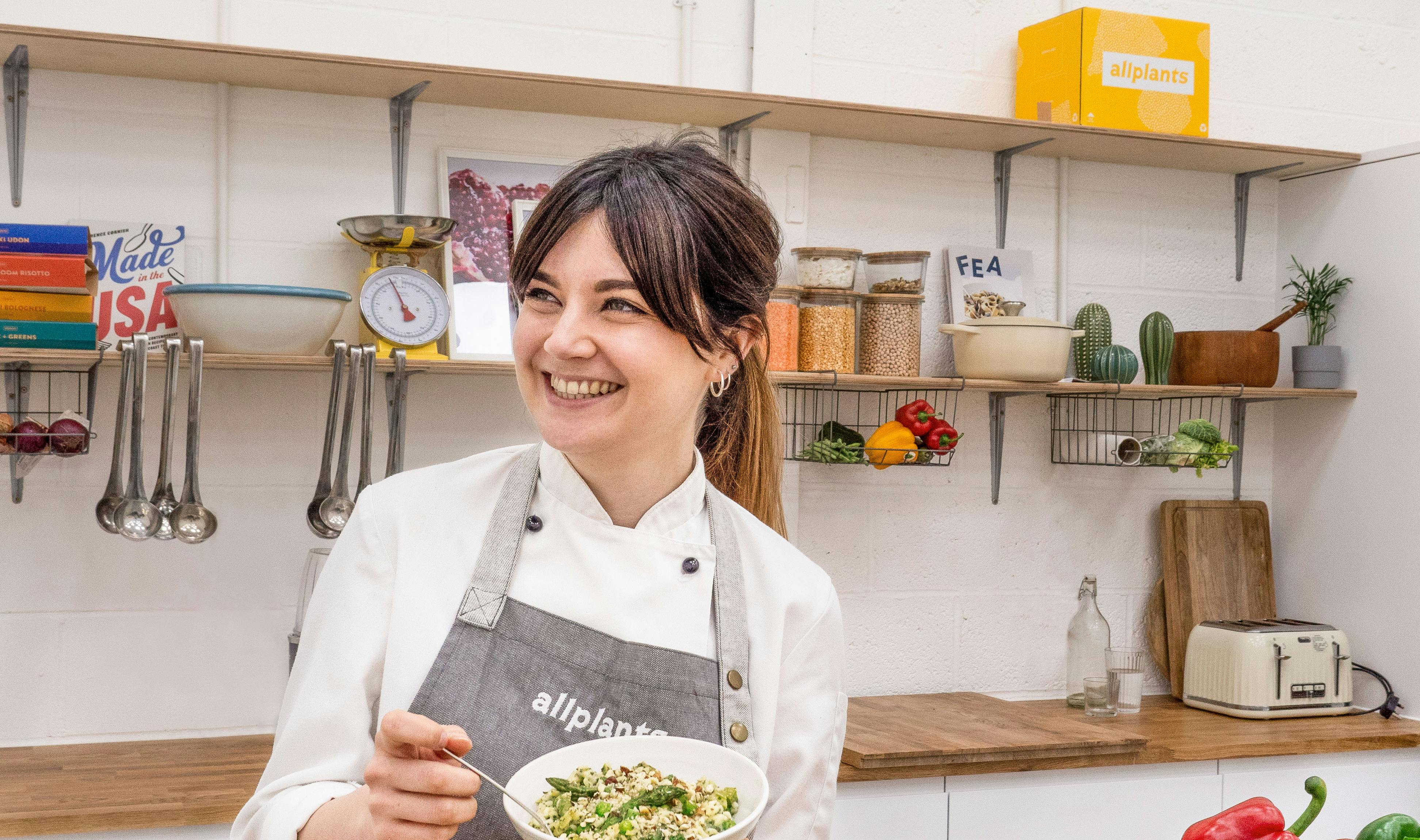 chef holding a bowl of risotto 