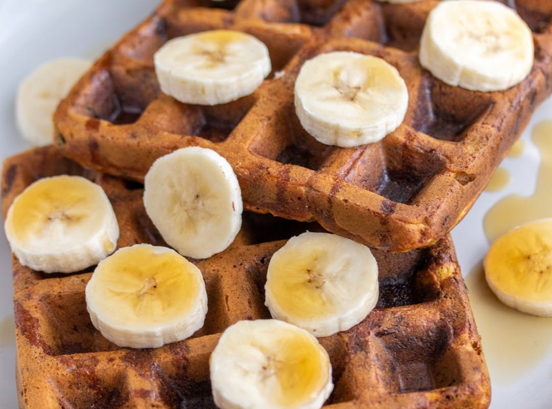 vegan waffles covered in banana