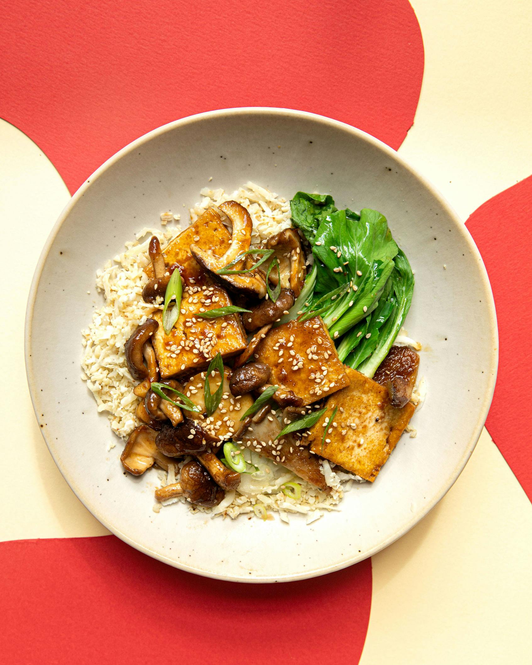 stir fry on plate with cream and red patterned background