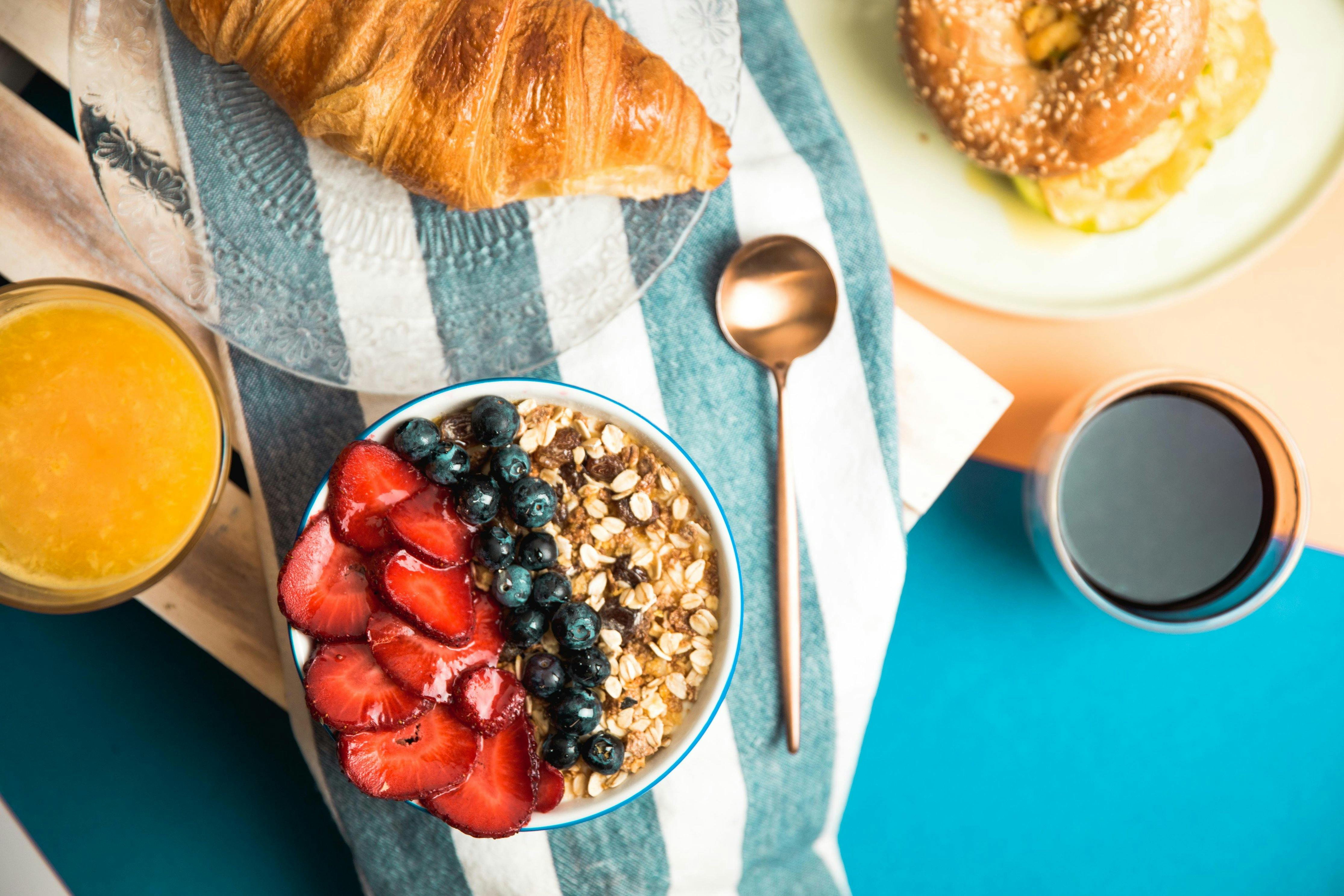 breakfast granola berries with juice and teapsoon