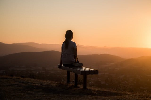 woman sittin gon a bench