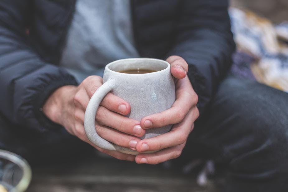 man holding tea