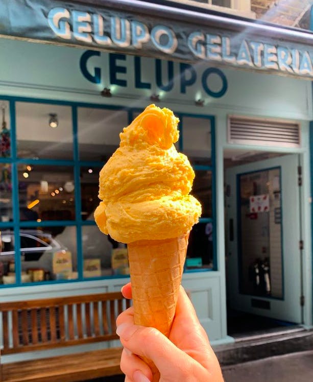 person holding ice cream cone outside Gelupo