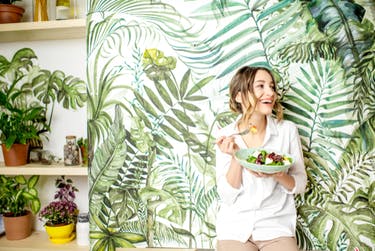 woman eating plate of vegan food 