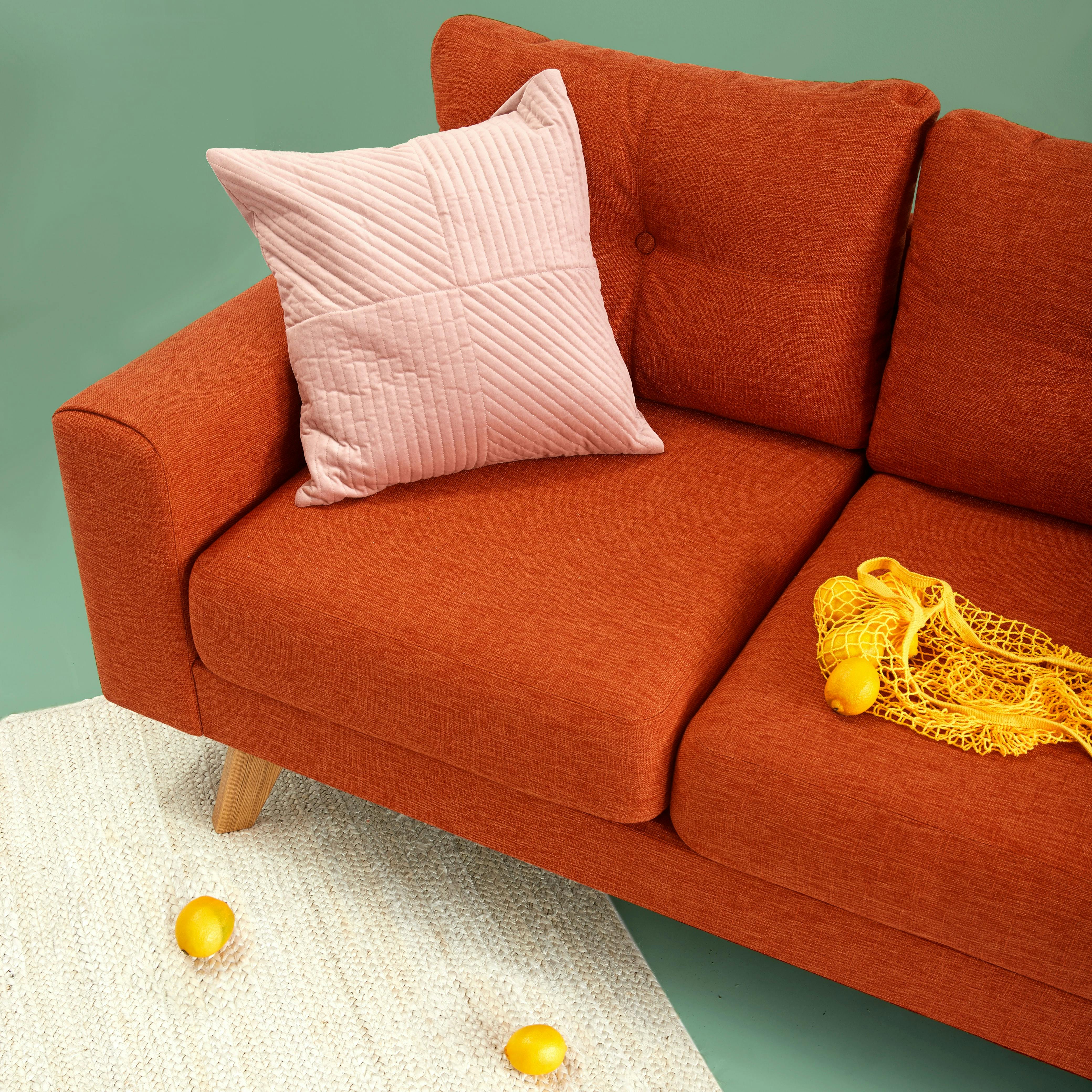 red sofa with lemons on it