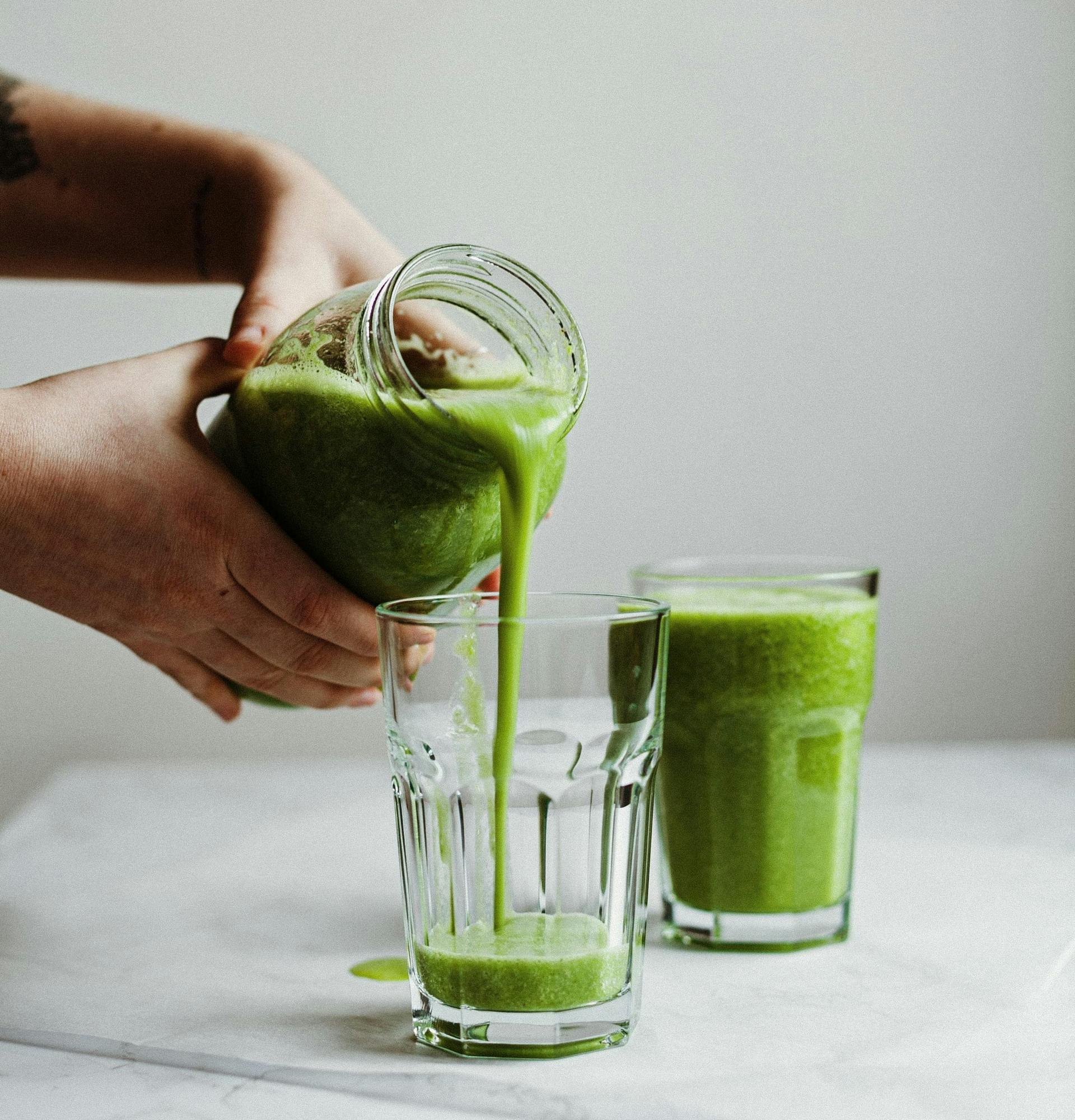 a green smoothie being poured
