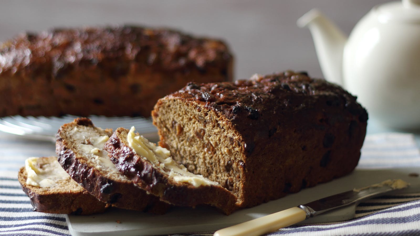 a  sliced malt loaf with vegan butter