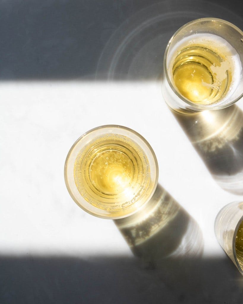 Image taken from a birdseye view of two glasses of kombucha.