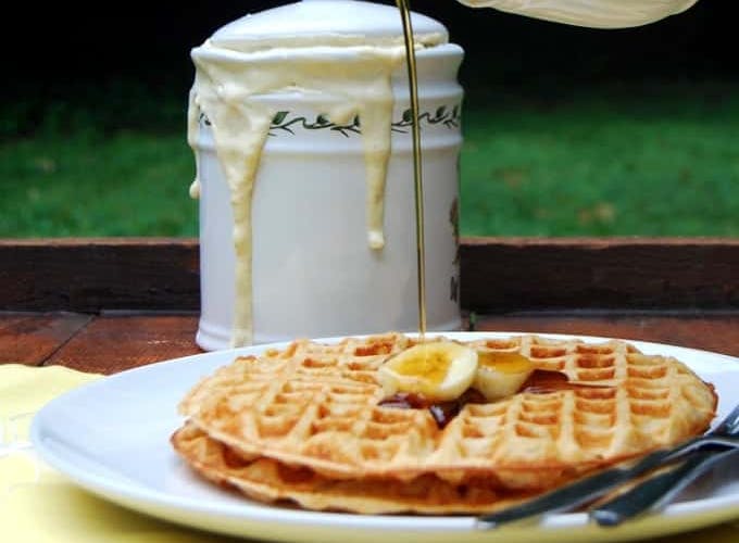 vegan waffles with syrup pouring over them