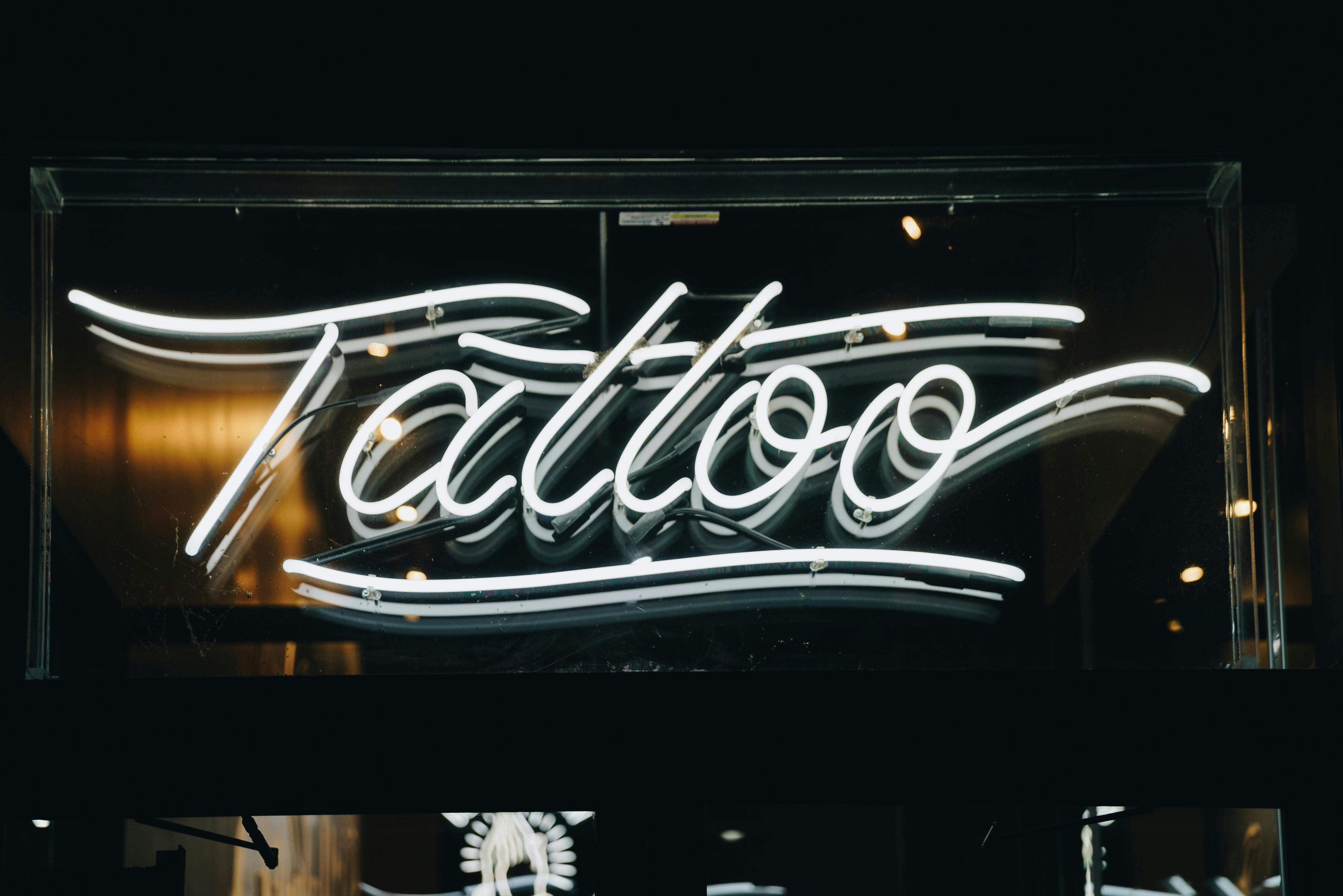 neon  sign saying 'tattoo'