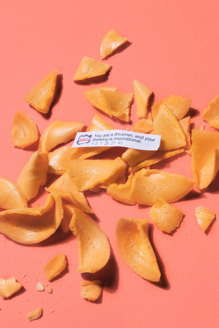 fortune cookies smashed on pink background