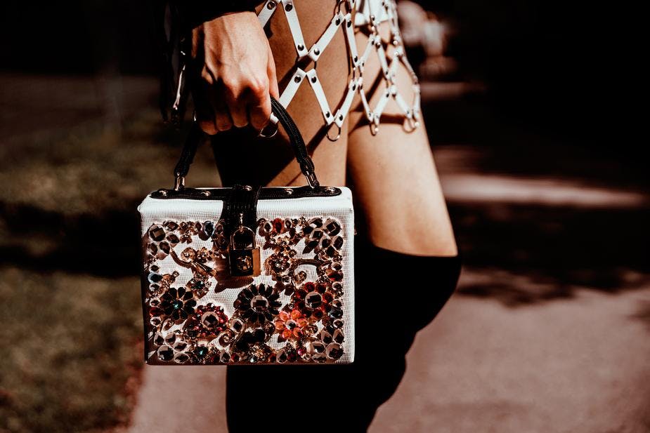 woman wearing skirt and holding bag