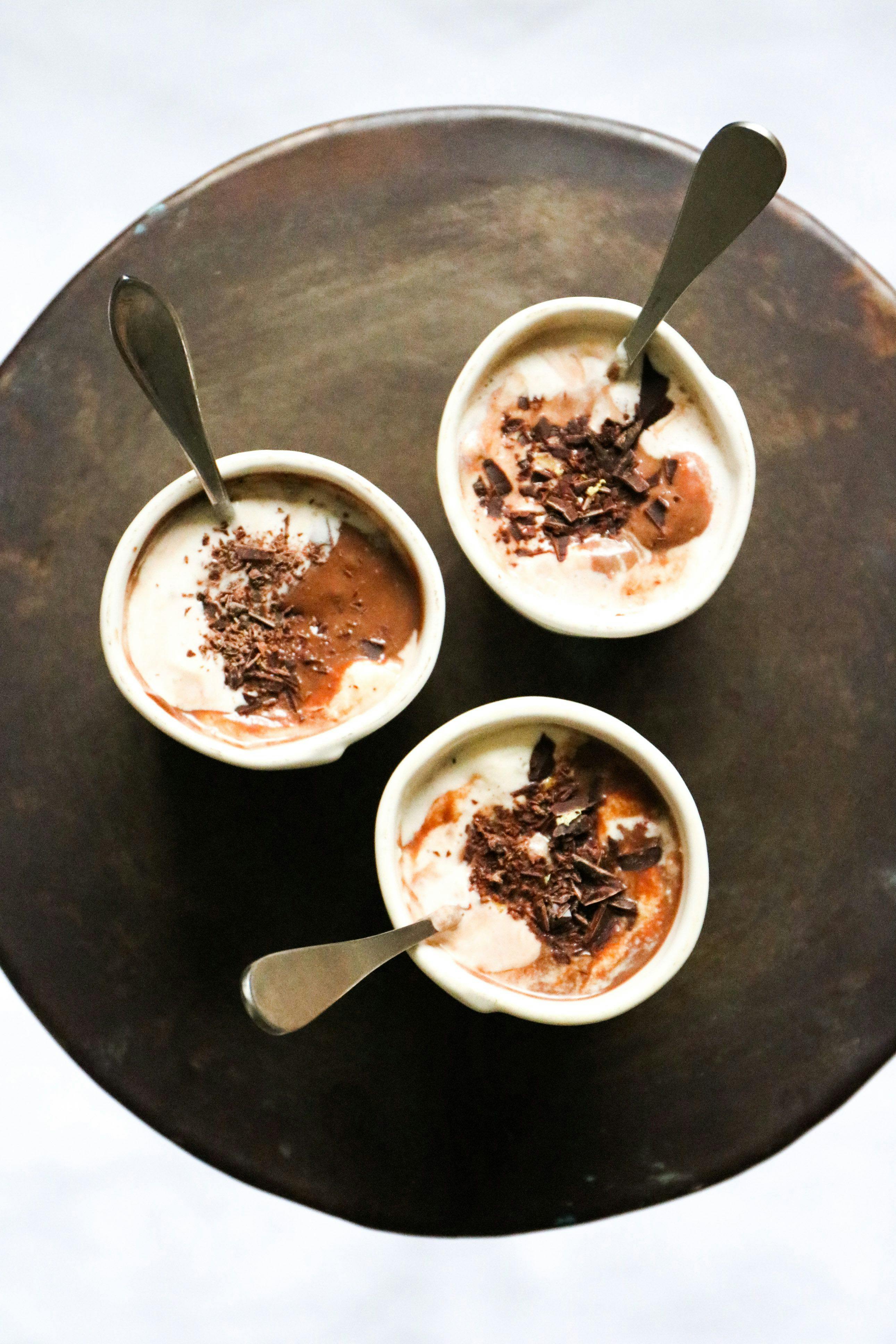 three mugs of hot choclate with spoons