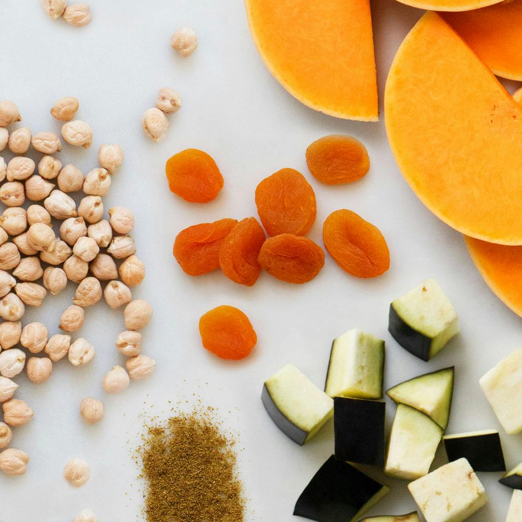 Chickpeas, apricots, aubergine, and spcies on table 