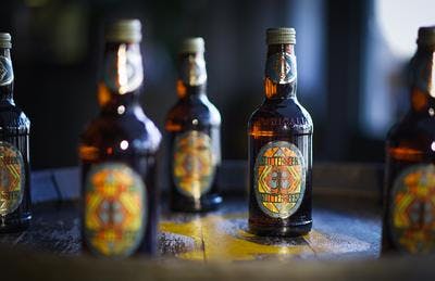 Bottles of Butterbeer on wooden table