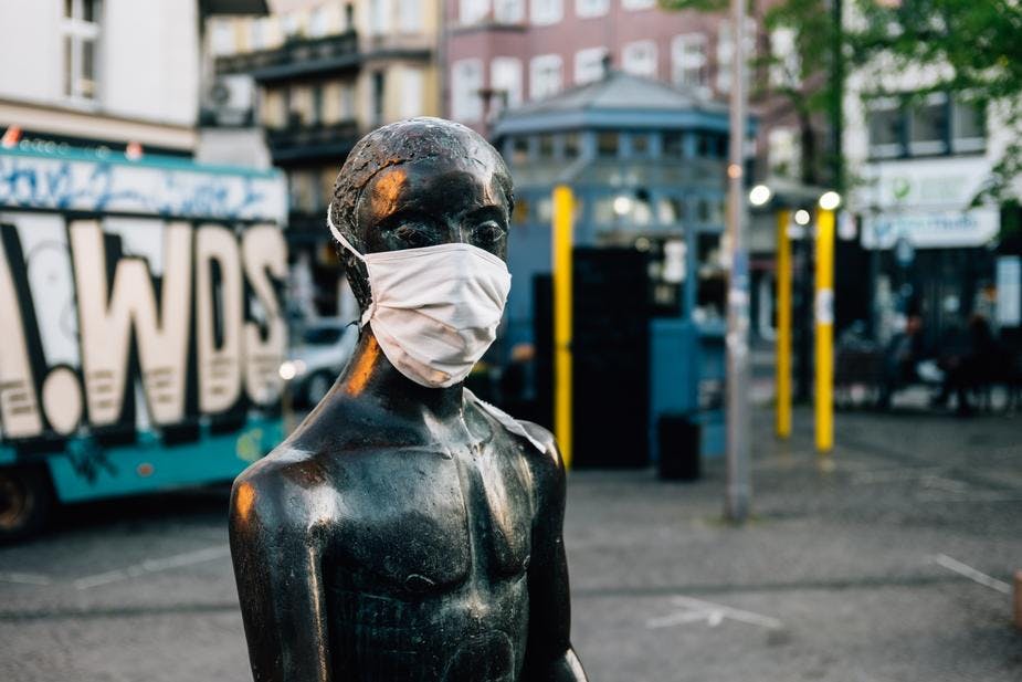 statue wearing face mask