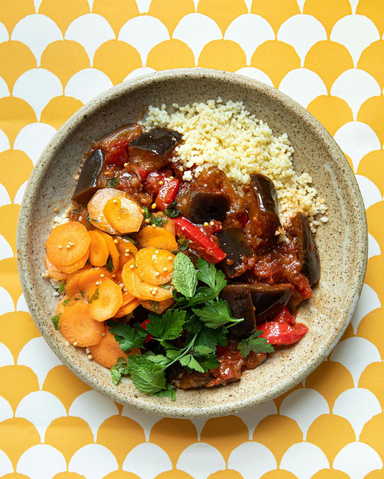 Aubergine pepper stew in bowl on yellow background