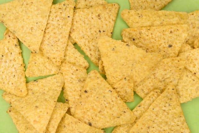 tortilla chips on green background