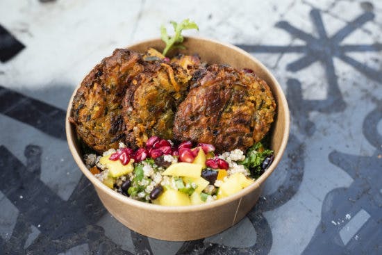 Brown pot of vegan food and salad