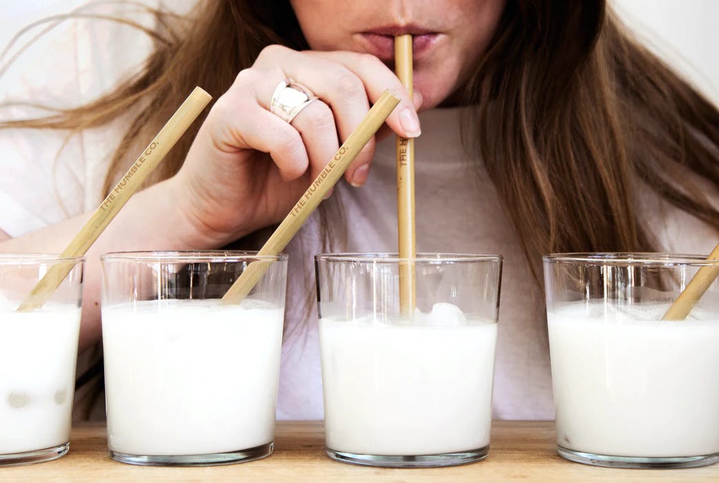 person drinking milk from straws