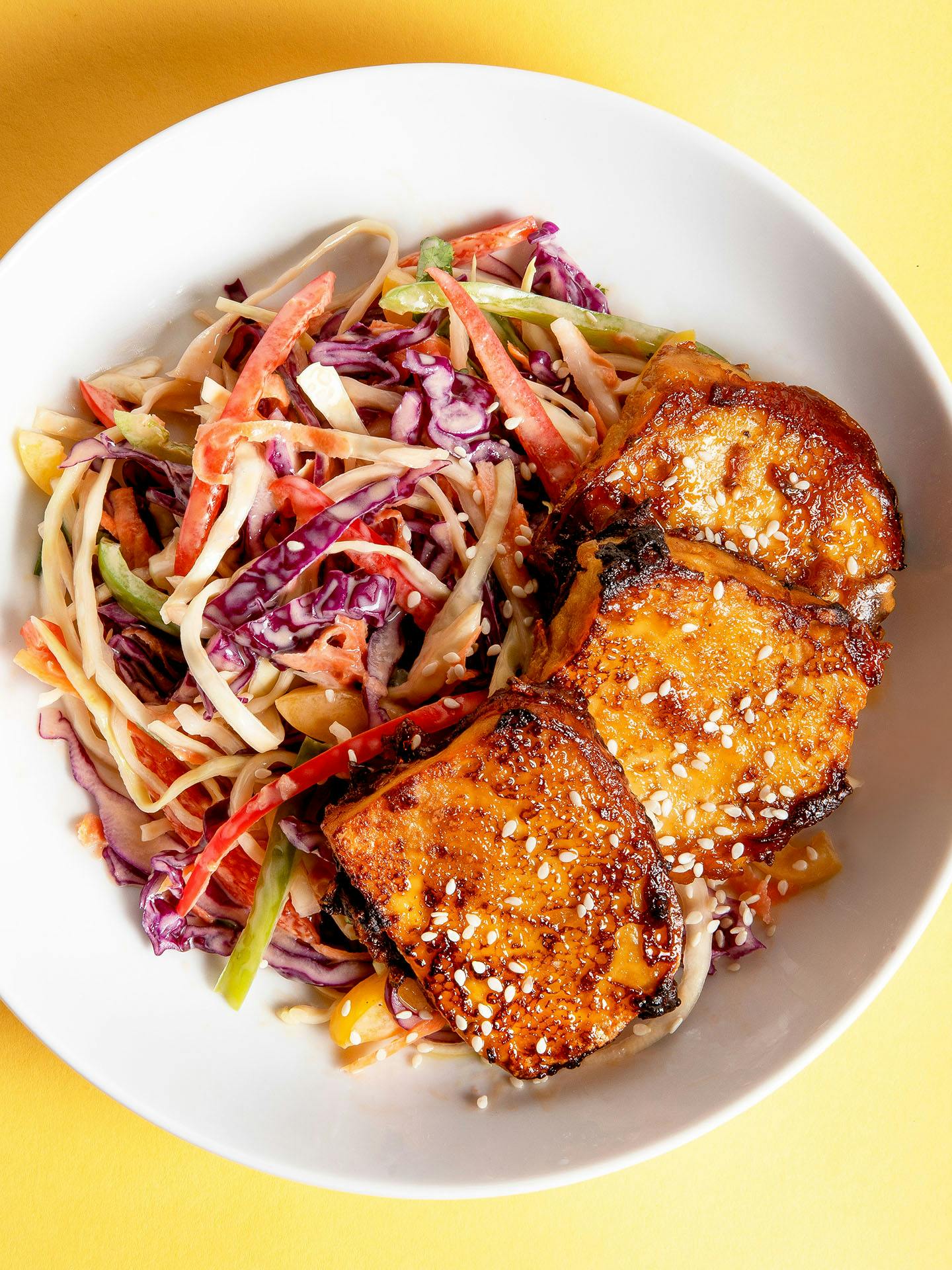 Crispy tofu served with rainbow slaw on the side