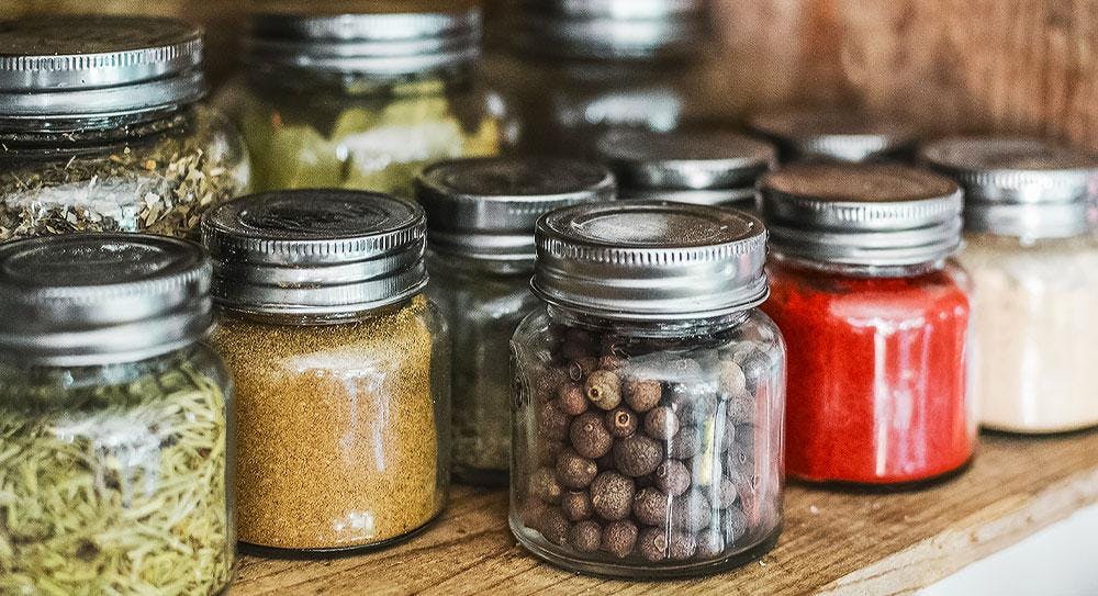 Herbs and spices stored in organised sealed jars