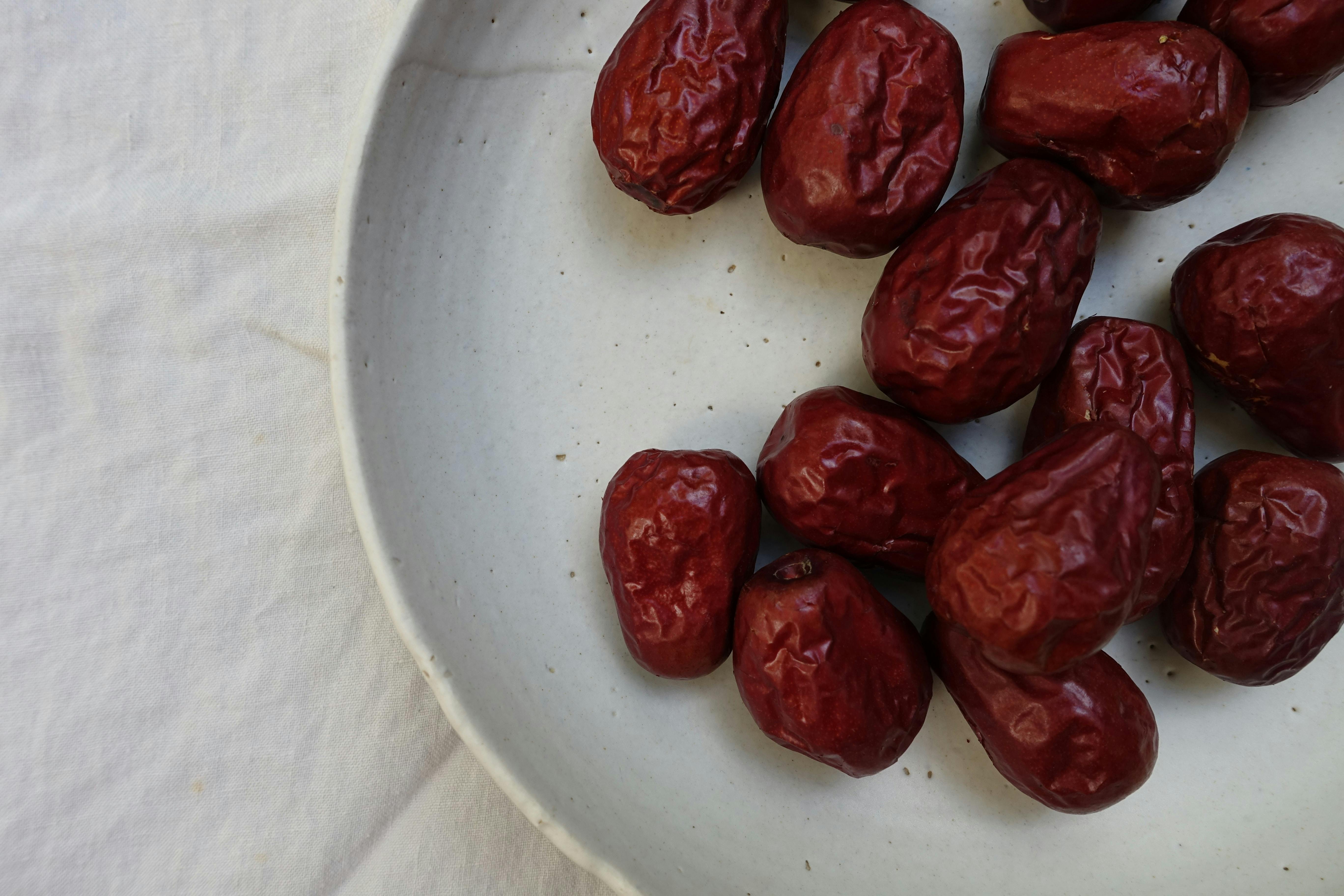 close shot of dates on a white plate