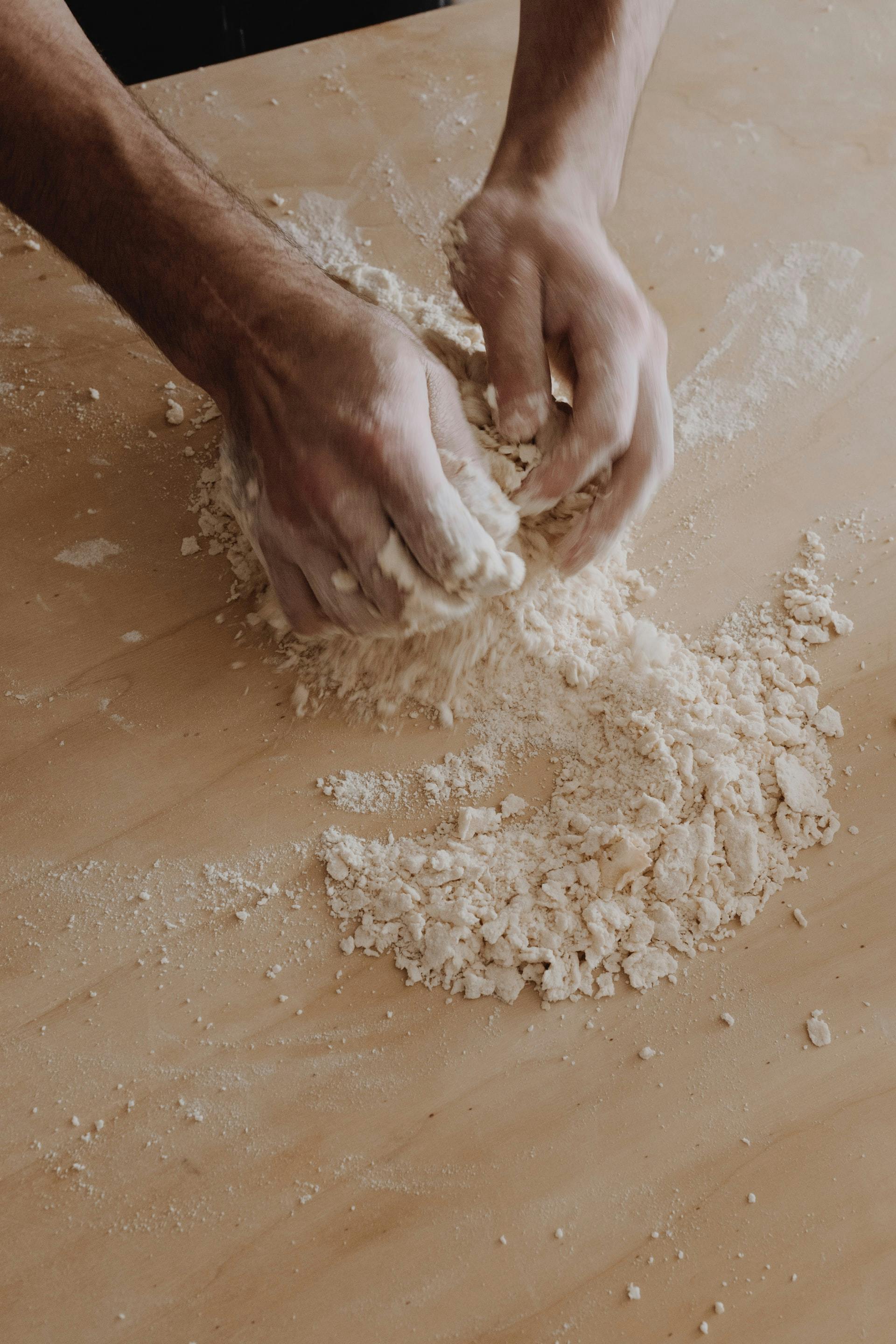 someone kneading dough