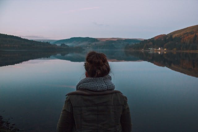 someone in front of a lake