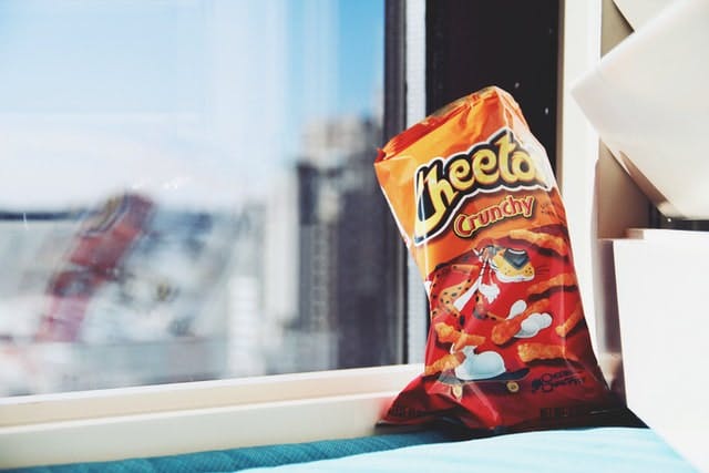 bag of cheetos on a windowsill 