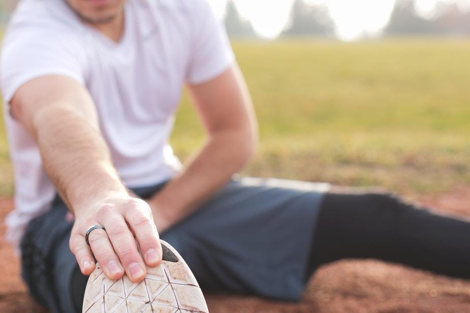 man stretching outdoors 