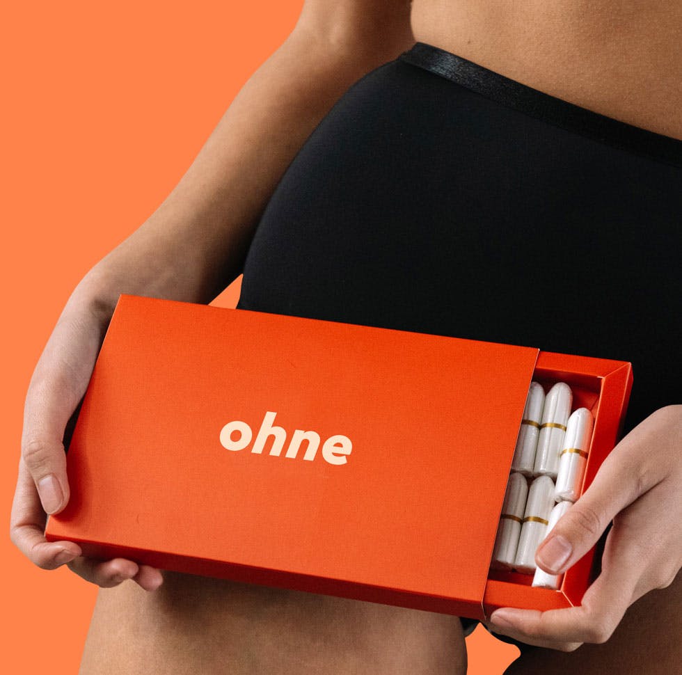 person holding box of biodegradable tampons 