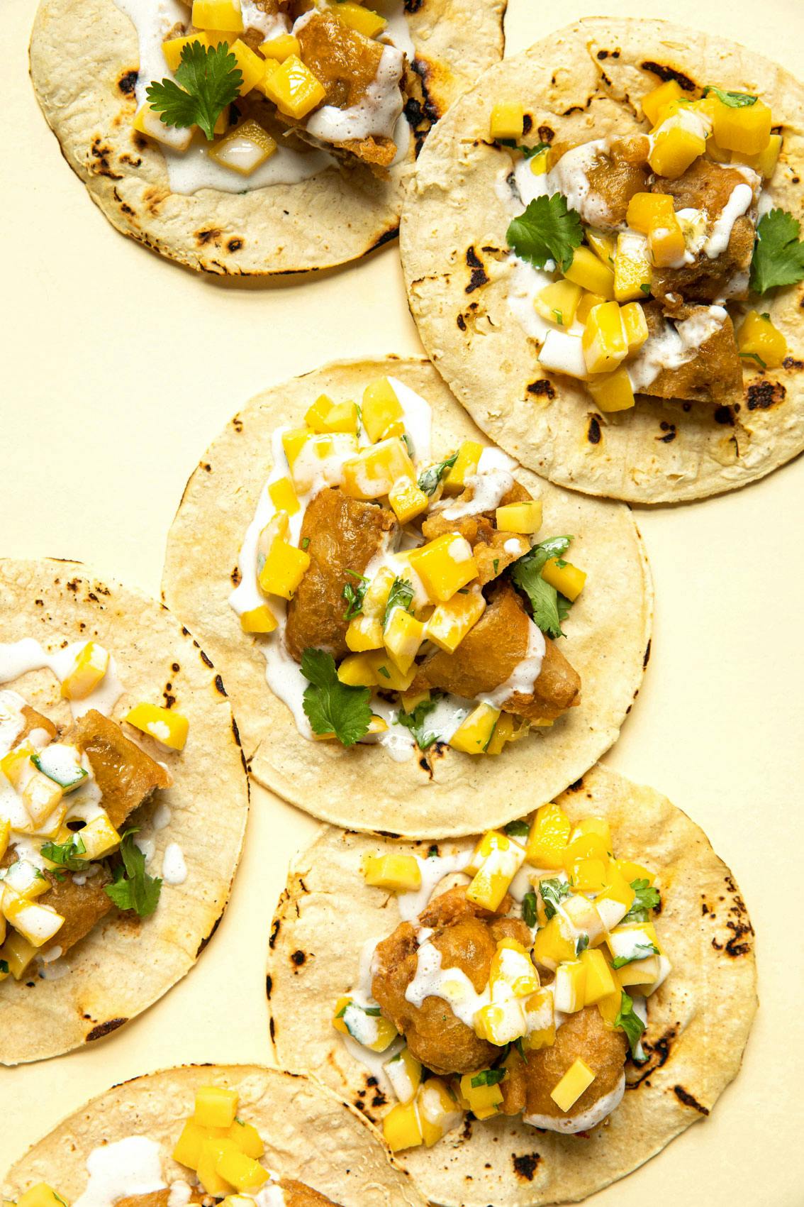 Fish tacos on yellow background