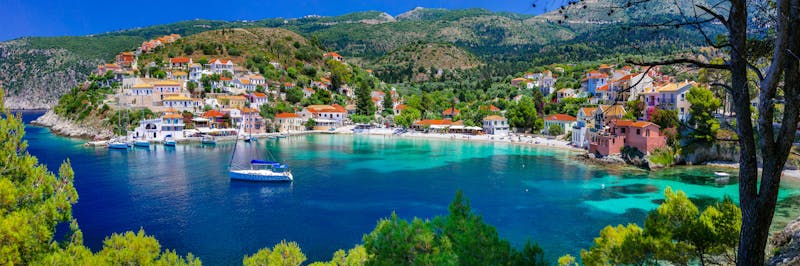 The picturesque bay of Assos, Kefalonia, Ionian islands, Greece. Chartered sailing yachts sit and motor in the harbour