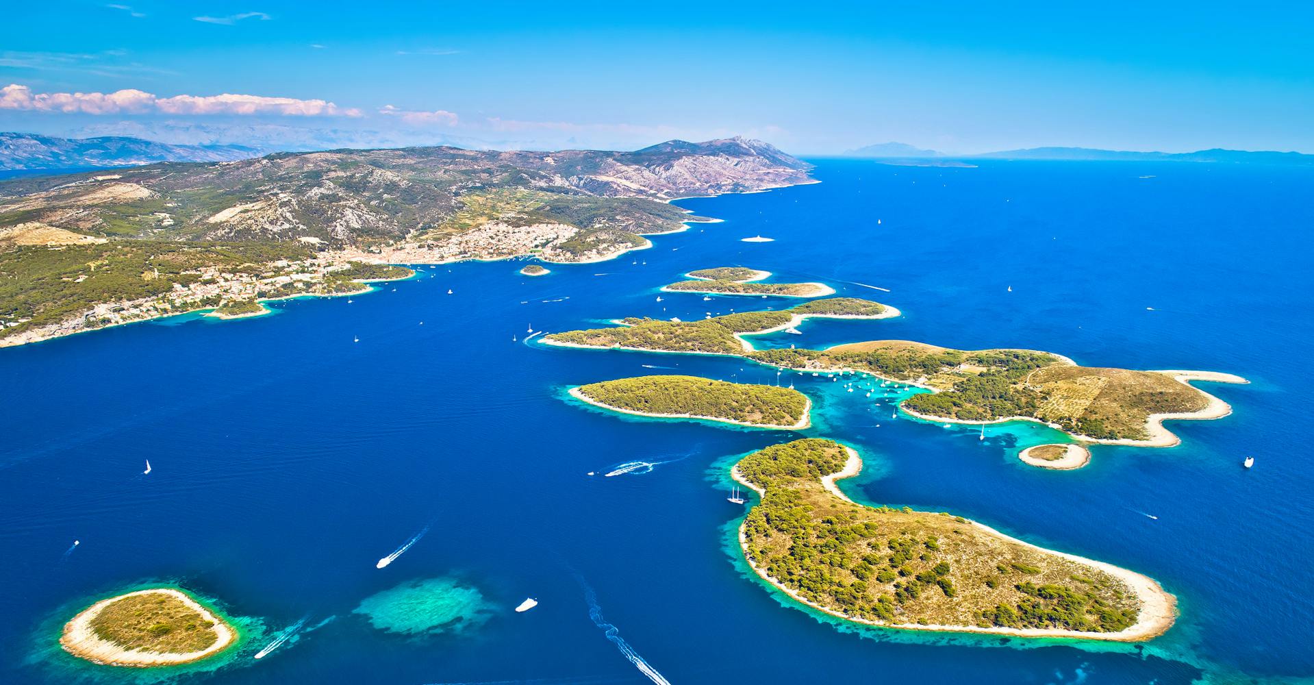 Aerial panoramic view sandy islands off Croatia. Yachts and speedboats travel between the islands