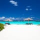 benches under cabana umbrellas on a white sand beach in Anegada, British Virgin Islands
