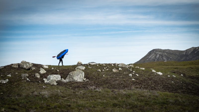 &#x201C;Sometimes the quickest way through the abstract topography of the Outer Hebrides is just to carry the boat and bike over small isthmuses to the next stretch of water. I found it easy enough to get the boat over my head and bushwhack through the heather to the next put-on, although the local tick population liked to use it as an opportunity to hitch a ride.&#x201D;&#x9D; Photo: Annie Lloyd-Evans