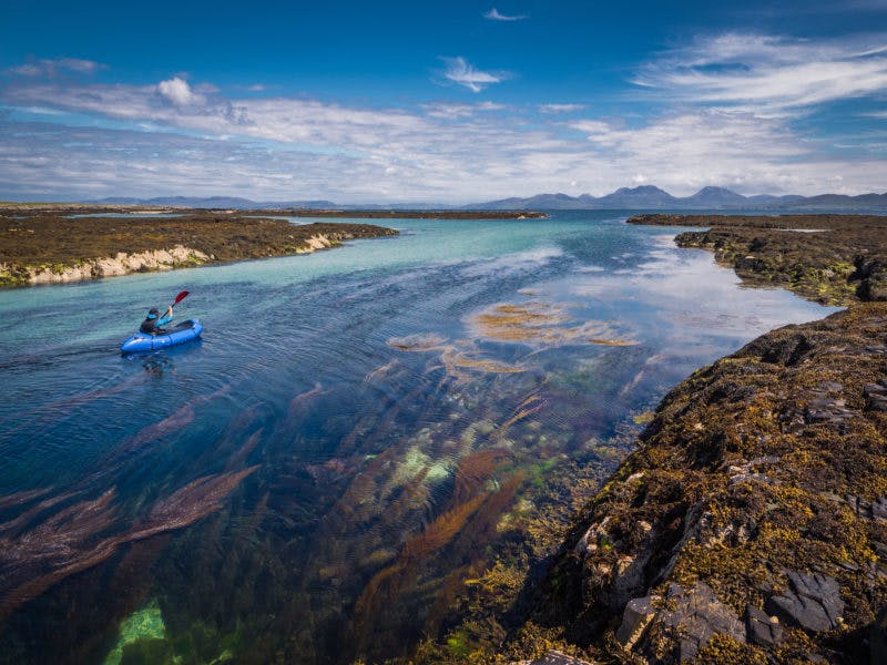 &#x201C;Off the island of Oronsay there is a small skerry named Eilean nan Ron, a gaelic name meaning island of the seals. We paddled out there as quietly as we could, rounding the corner to see a dozen or so lazing on the rocks, snorting indignantly at each other and doing a very good impression of some grumpy geriatrics. They were beautiful to watch. After a while we left them to it, and rode the strong tide race down this channel, with the Paps of Jura and the famous whisky-producing island of Islay in the distance. There was always at least one seal bobbing alongside to keep an eye on us until we had been safely escorted off the premises.&#x201D;&#x9D; Photo: Annie Lloyd-Evans