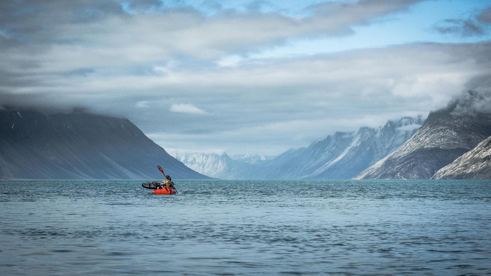 &quot;At some point we had to cross the fjord, but we were pretty nervous as for several days we had watched the wind whip up big swells far more quickly than we could make the 4km crossing. The evening when we finally went for it, we had been awake from 5am to catch the tide, ridden the swells nearly 40km and then had to jump off the water as the tide swung against us. We watched and waited, the wind dropping but the swell hanging around much longer. Eventually, after much deliberation, we decided to cross, paddling in the gorgeous evening light and making it across about 20min before the wind picked up again so strongly that we had to make another fast exit to camp.&quot; ~Annie Le Evans