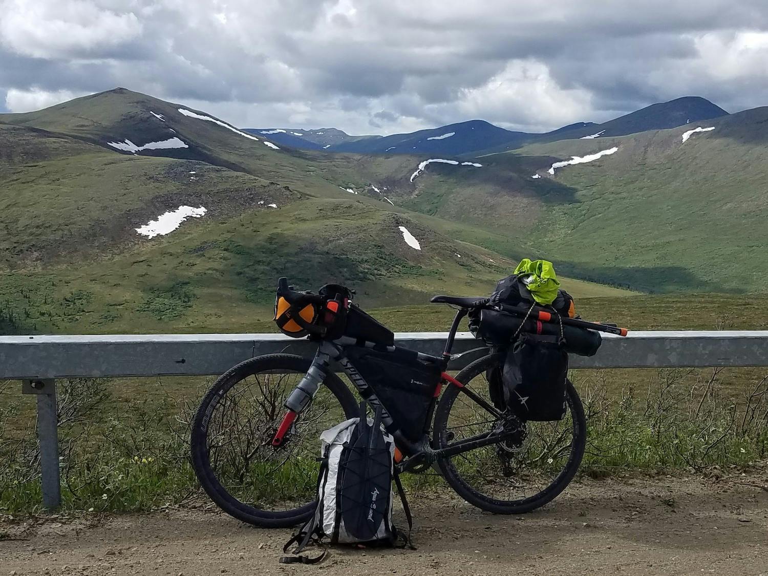 My bike with the boat lashed to the rear rack, PFD and paddle in a small daypack