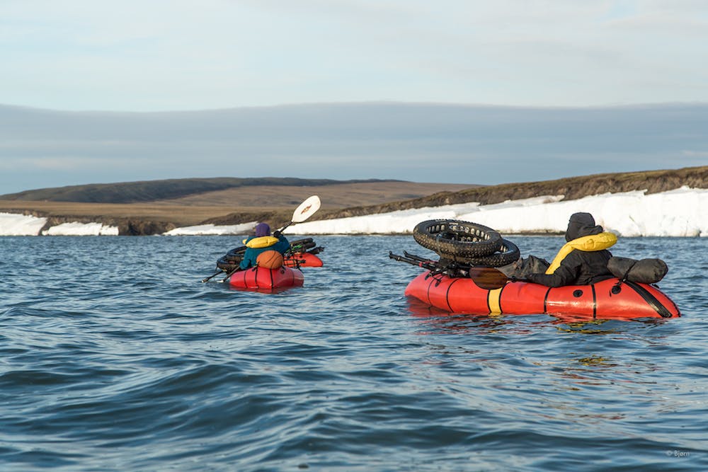 Packrafting in Front of Corwin: Three Alaskan adventurers packraft in front of the Corwin bluffs in the far north of Arctic Alaska. As the four-person team made their way from Point Hope to Utqiagvik by fat-bike, they often employed Alpacka packrafts to cover unrideable terrain.&#xA0;