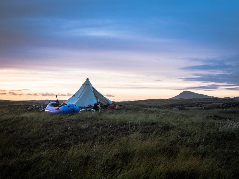 &quot;The straight-line distances we travelled between camp spots weren&#xE2;&#x20AC;&#x2122;t always that far, but then again a journey is more than the sum total of the ground covered &#xE2;&#x20AC;&#x201C; from this bleak spot beside the rocky east coast of Benbecula we navigated a maze of tidal channels accompanied by seals, and several portages later we pitched up the next night beneath Eabhal (&#xE2;&#x20AC;&#x2DC;Ey-Val&#xE2;&#x20AC;&#x2122;), the highest point of North Uist, which can be seen in the background. The view from the summit at sunset included the eery silhouette of the St Kilda archipelago, 40 miles out into the Atlantic.&quot; Photo: Huw Oliver