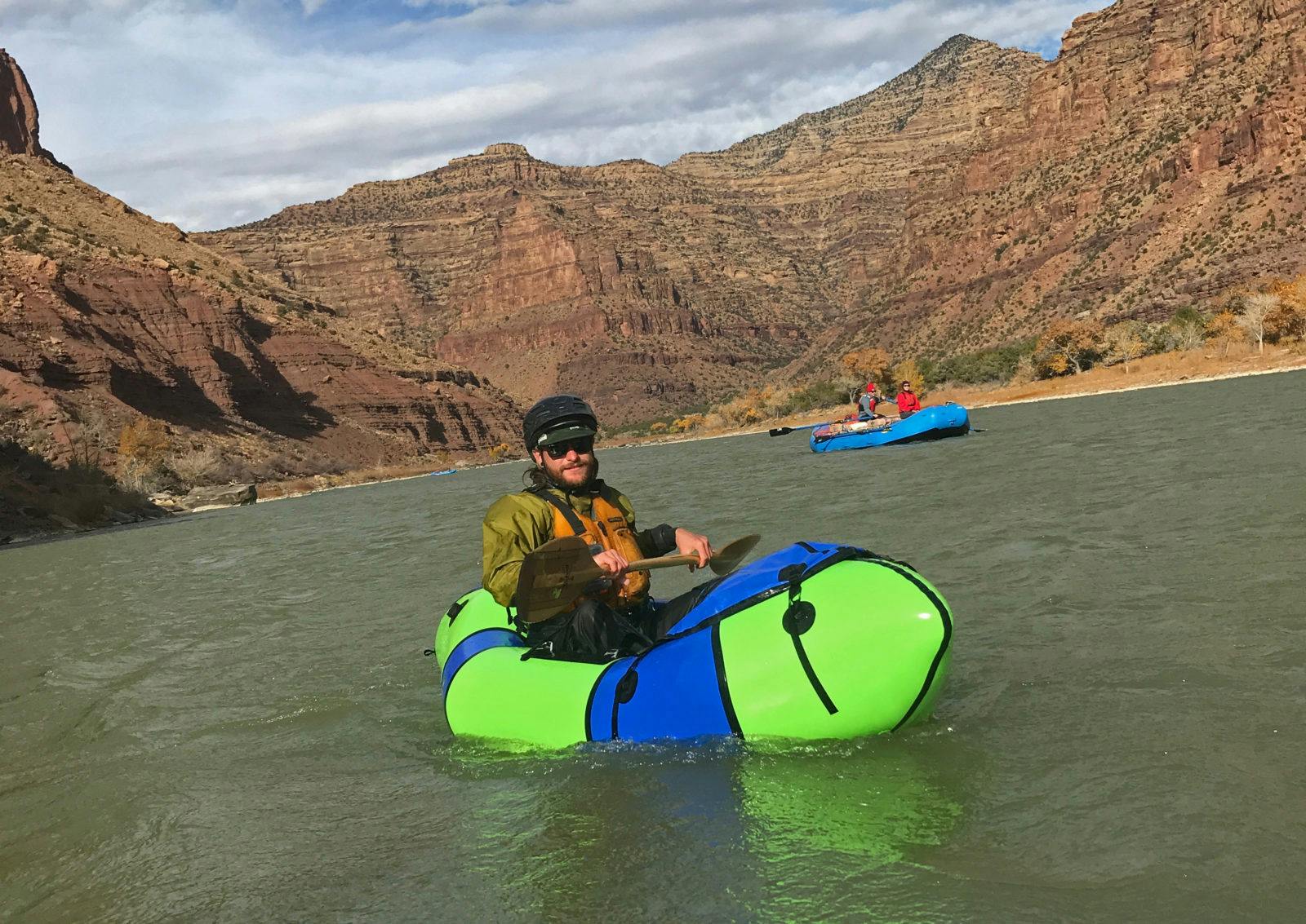 Tyler Marlow in a lime green Gnarwhal boating Desolation Canyon during a Halloween Deso-Grays trip on the Green River, Utah. Photo by Lizzy Scully.