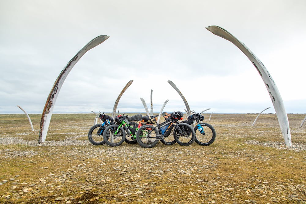 Loaded fat-bikes rest against a bowhead whale bone garden in the village of Point Hope. In the summer of 2017, four Alaskan adventurers, Bj&#xF8;rn Olson, Kim McNett, Daniel Countiss and Alayne Tetor, set out from the village of Point Hope with the aim of cycling and packrafting to the northern-most community in the U.S., Utqiagvik (formerly Barrow).&#xA0;