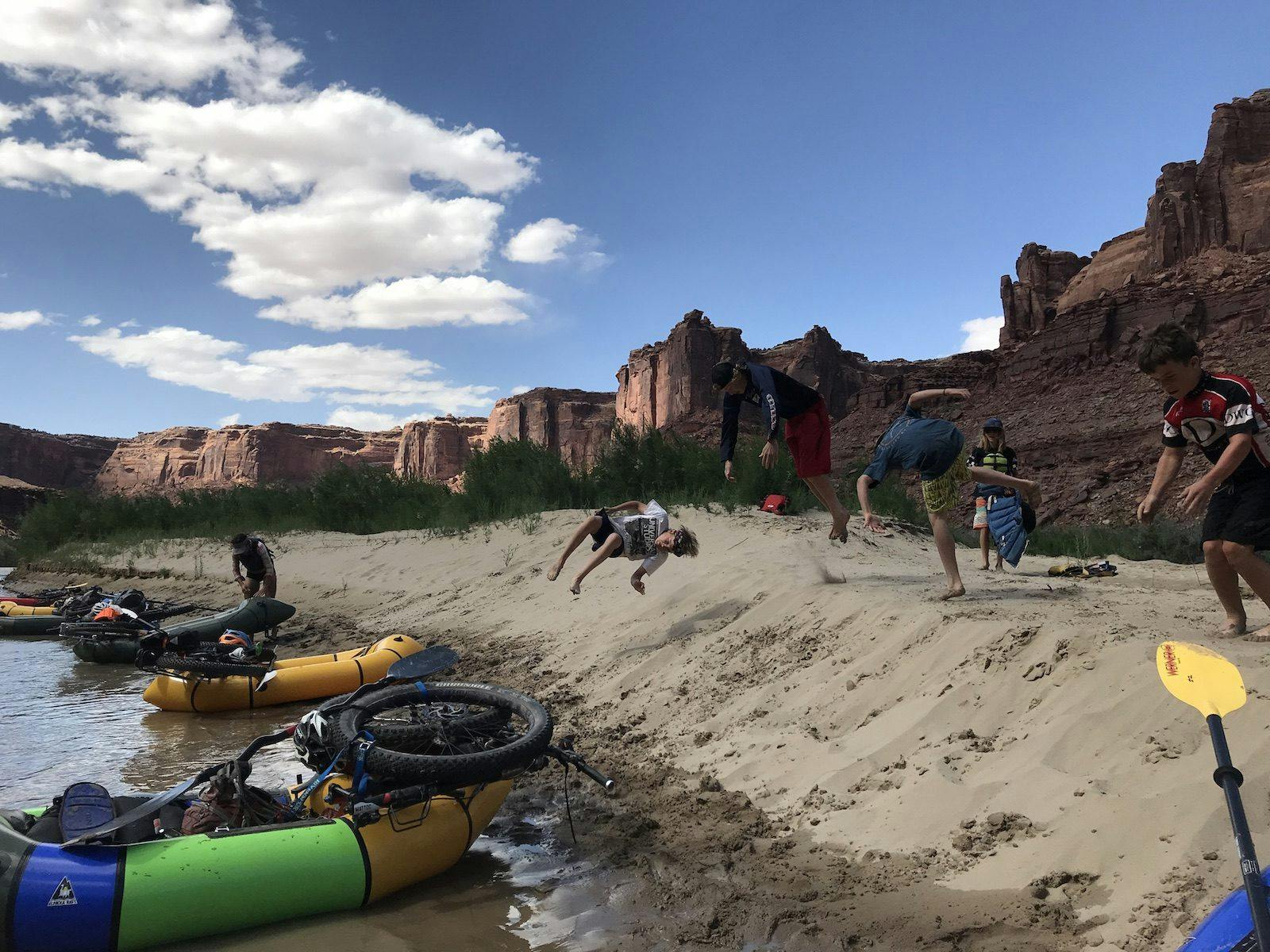 Taking a break from the wind on a beach.&#xA0; Kids were tired of paddling into the wind so instead they took a break by hucking themselves over the sandy embankment.